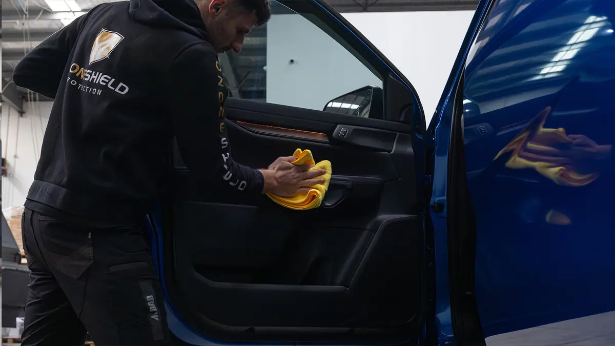 OzoneShield technician treating a vehicle door trim