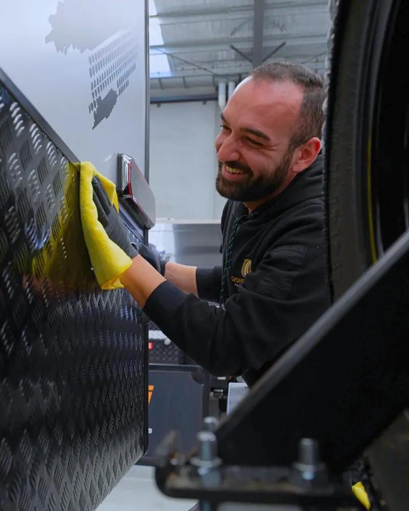 Smiling OzoneShield technician at work on a caravan